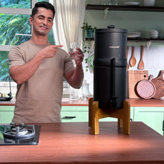 Man standing in a kitchen with a coffee machine on a counter