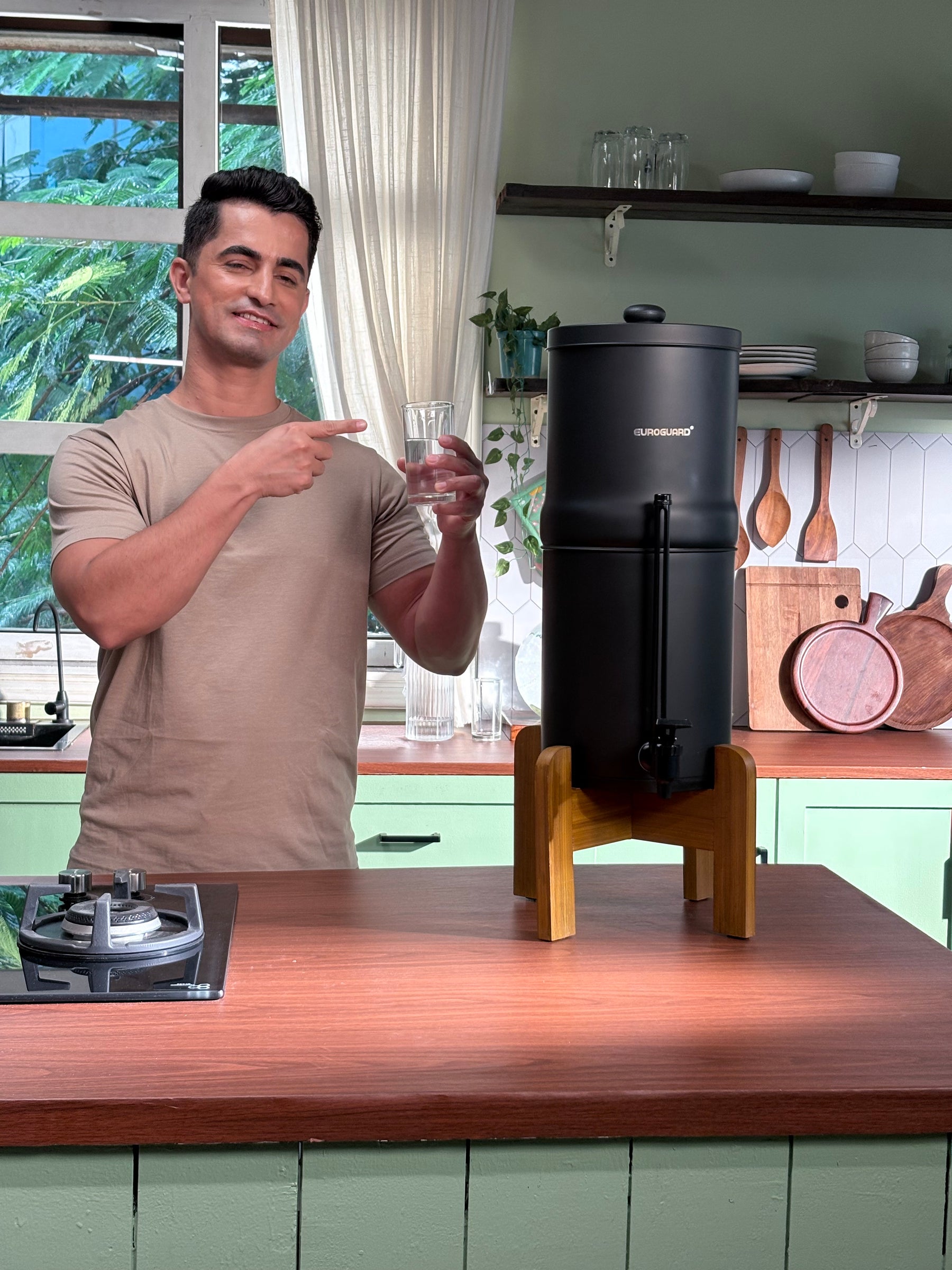 Man standing in a kitchen with a coffee machine on a counter